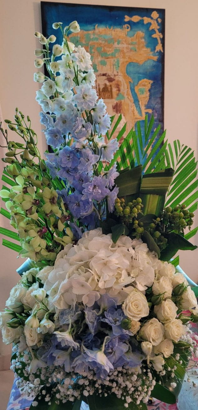 bouquet of flowers in a vase with a painted map of Bahrain behind them